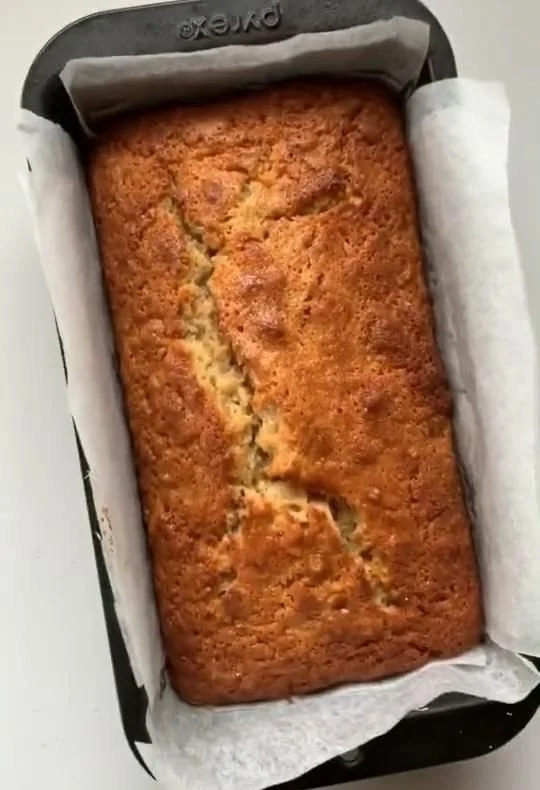 Deliciously baked banana bread loaf with slices ready to enjoy.