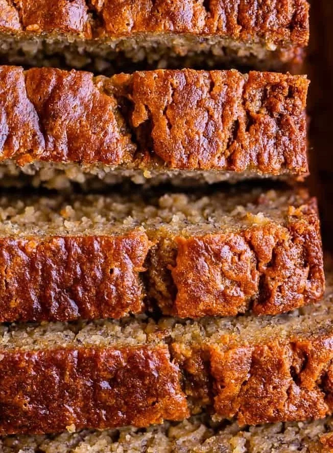 Deliciously moist homemade banana bread on a wooden table