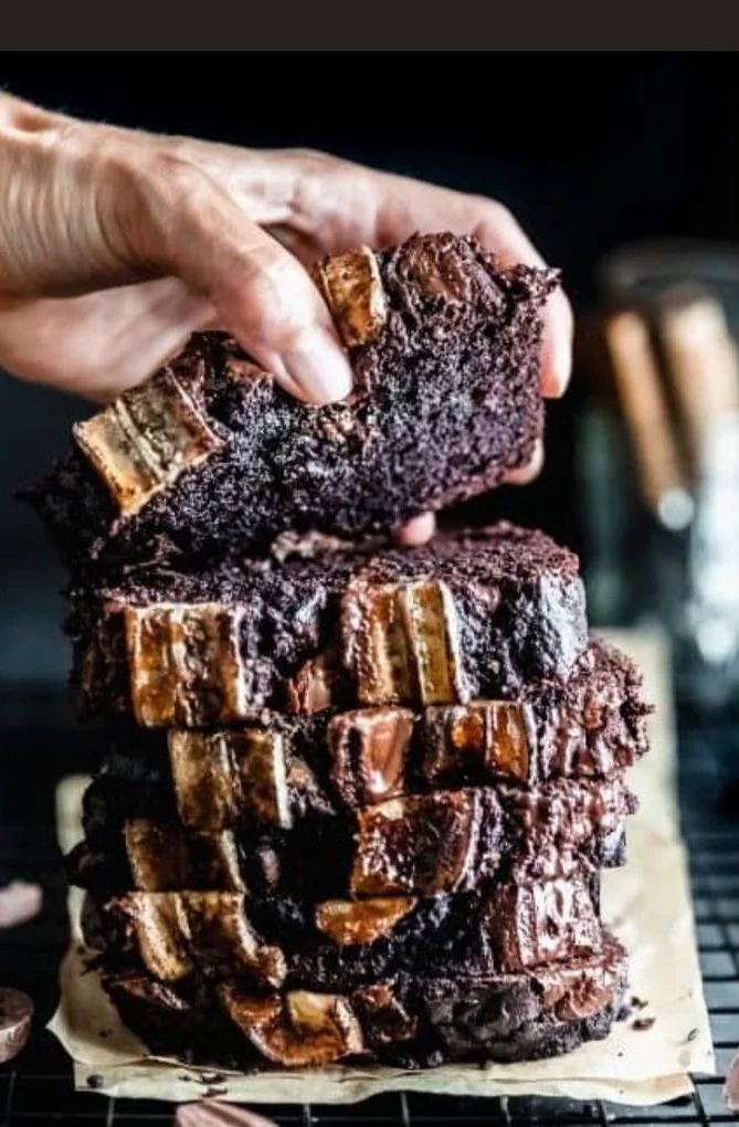 Sliced Chocolate Espresso Banana Bread on a wooden board with coffee beans